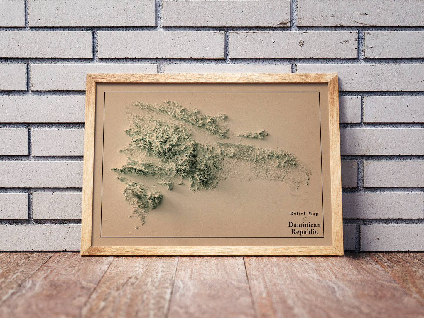 Vintage Dominican Republic shaded relief map in a wooden frame. Realistic terrain art print for home decor, displayed against a brick wall