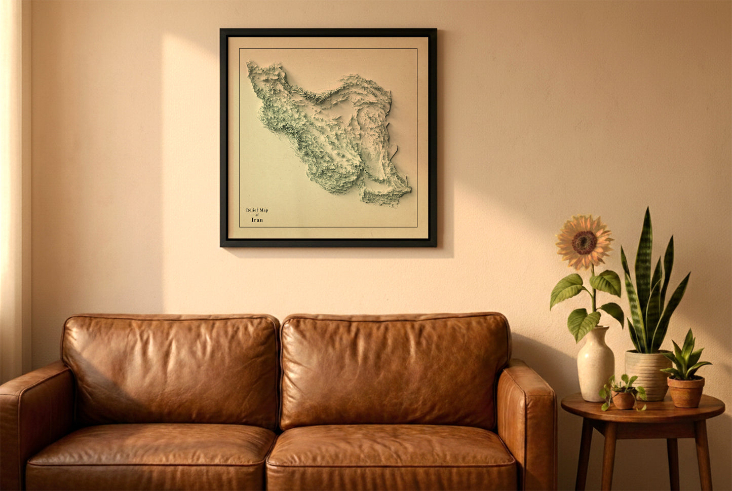 Iran vintage relief map in a black frame above a brown leather sofa. Boho living room with warm sunlight, sunflower, and indoor plants on a wooden side table