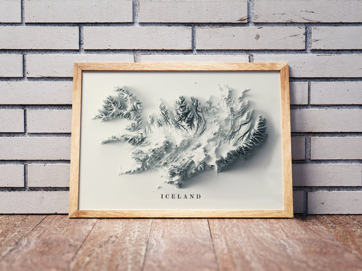 Vintage Iceland shaded relief map in a wooden frame. Realistic terrain art print for home decor, displayed against a brick wall