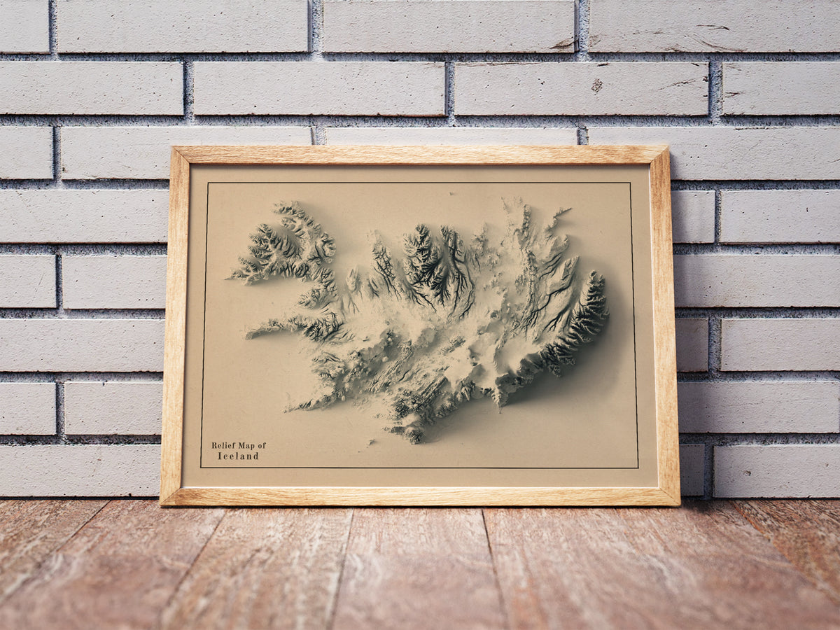 Vintage Iceland shaded relief map in a wooden frame. Realistic terrain art print for home decor, displayed against a brick wall