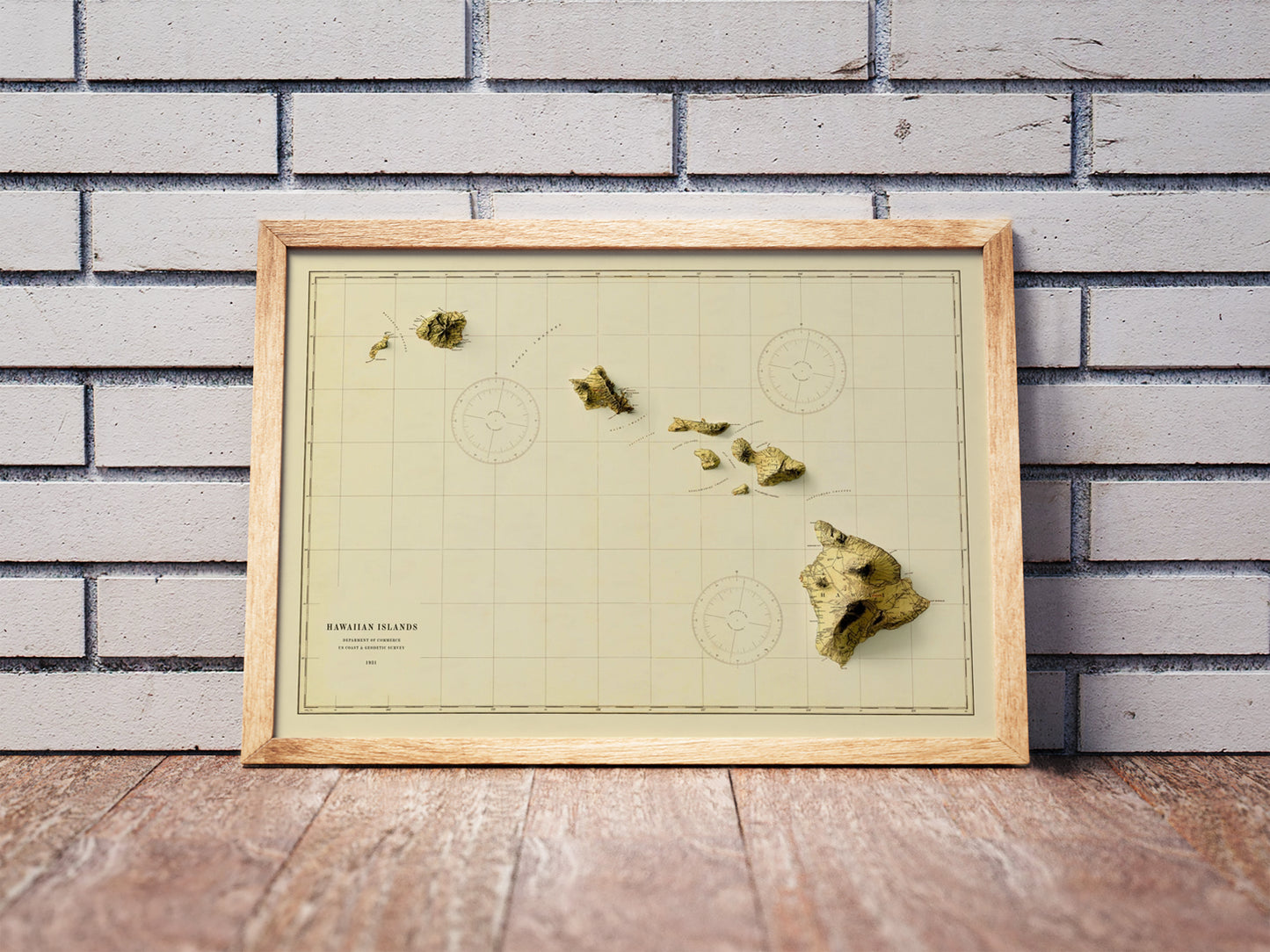 Vintage Hawaii shaded relief map in a wooden frame. Realistic terrain art print for home decor, displayed against a brick wall