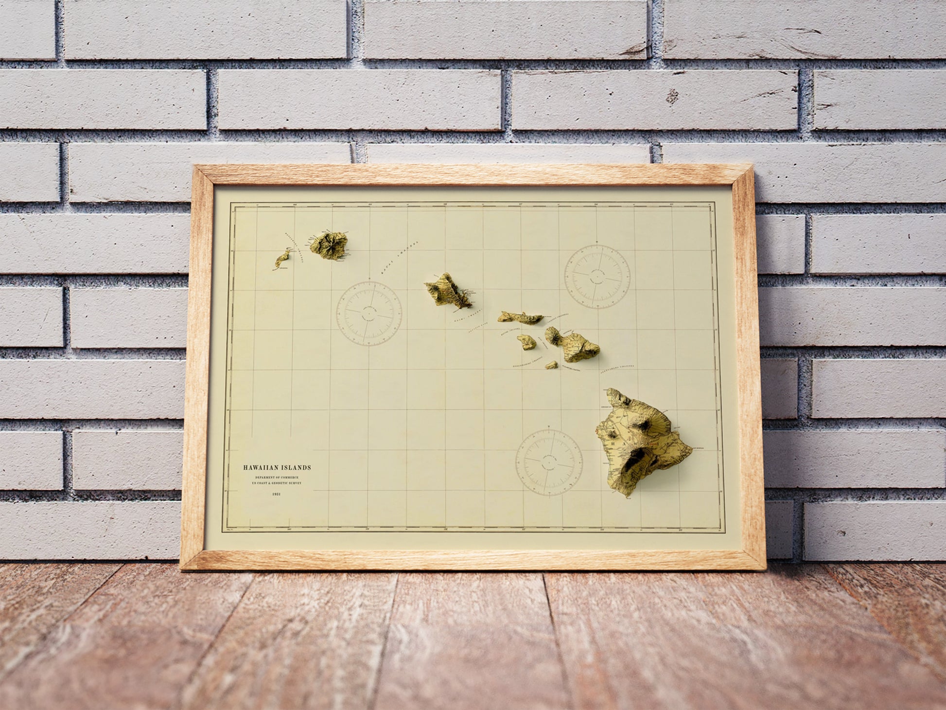 Vintage Hawaii shaded relief map in a wooden frame. Realistic terrain art print for home decor, displayed against a brick wall