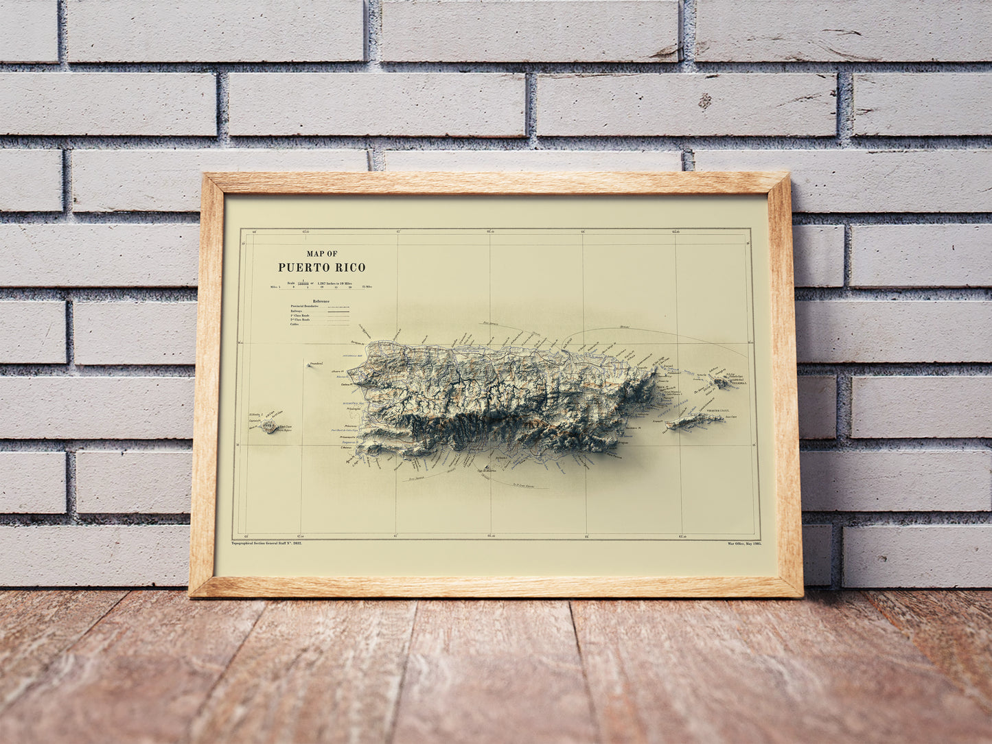 Vintage Puerto Rico shaded relief map in a wooden frame. Realistic terrain art print for home decor, displayed against a brick wall