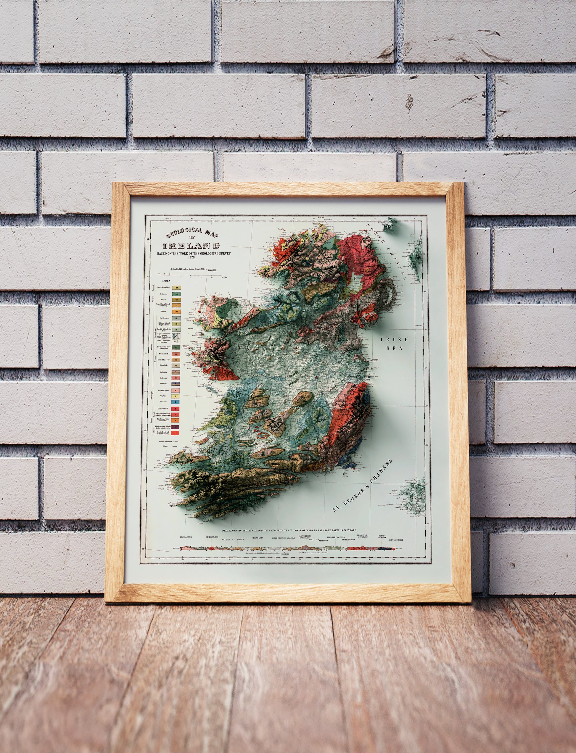 Vintage Ireland shaded relief map in a wooden frame. Realistic terrain art print for home decor, displayed against a brick wall