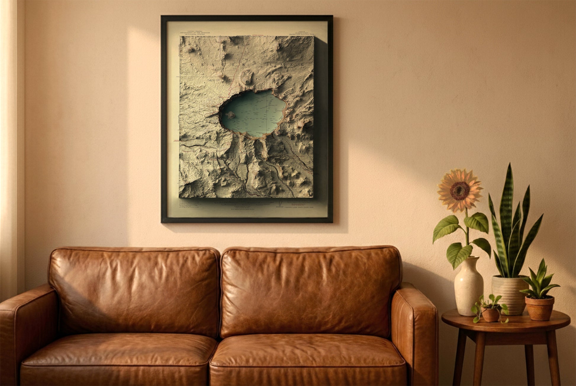 Crater Lake, Oregon, vintage relief map in a black frame above a brown leather sofa. Boho living room with warm sunlight, sunflower, and indoor plants on a wooden side table