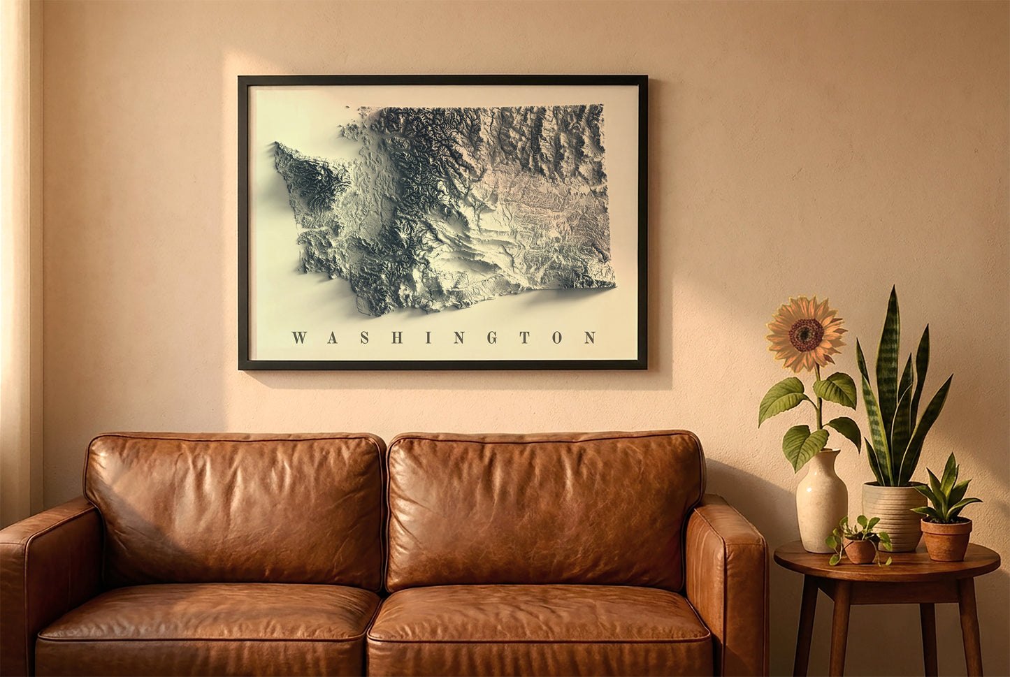 Washington relief map in a black frame above a brown leather sofa. Boho living room with warm sunlight, sunflower, and indoor plants on a wooden side table