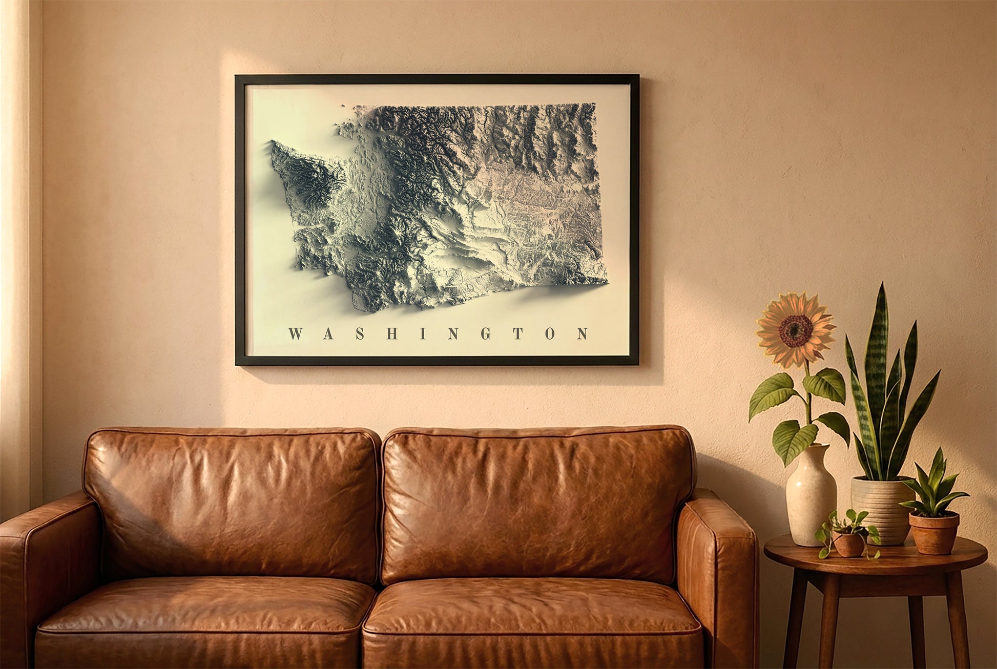 Washington relief map in a black frame above a brown leather sofa. Boho living room with warm sunlight, sunflower, and indoor plants on a wooden side table