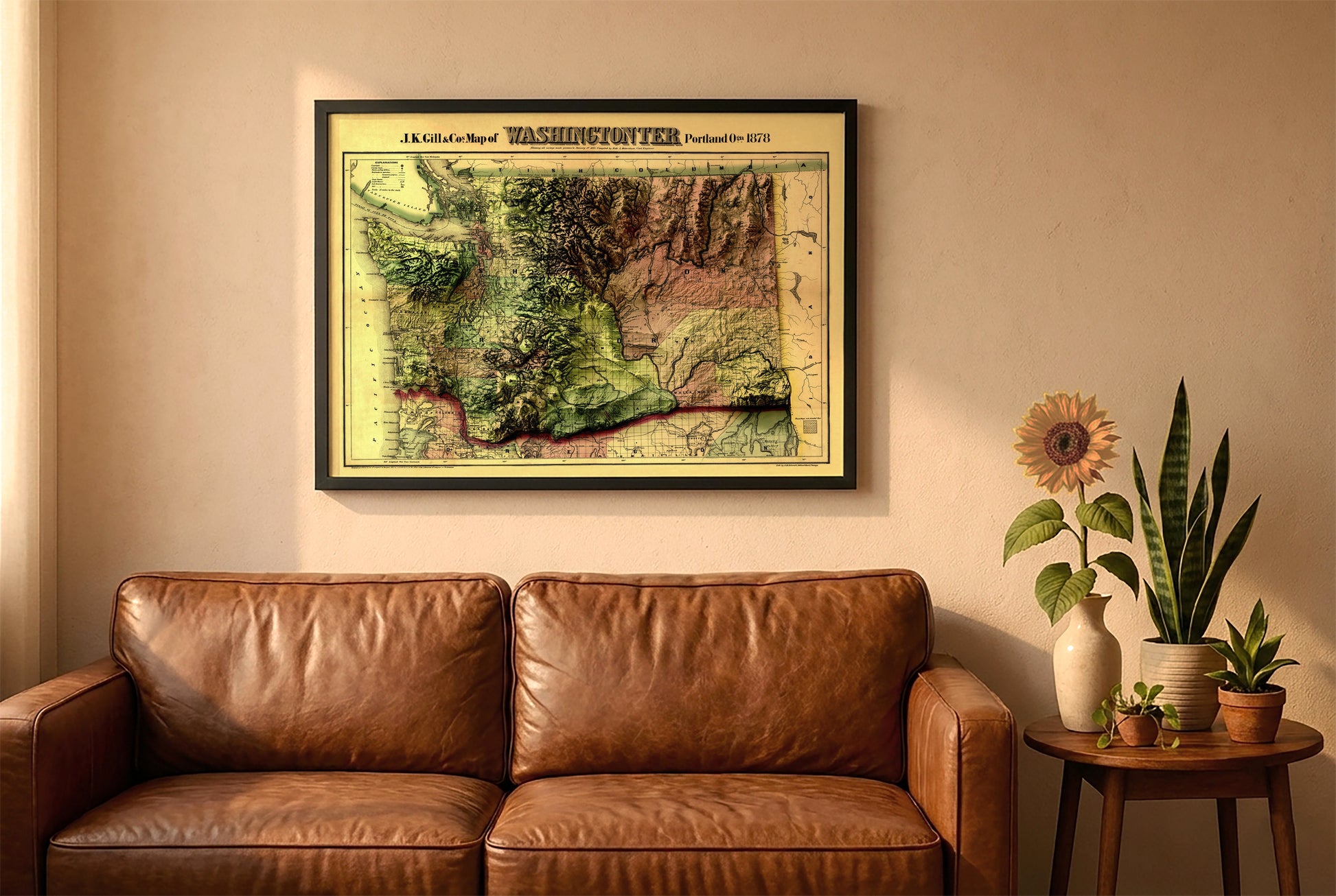 Washington vintage relief map in a black frame above a brown leather sofa. Boho living room with warm sunlight, sunflower, and indoor plants on a wooden side table