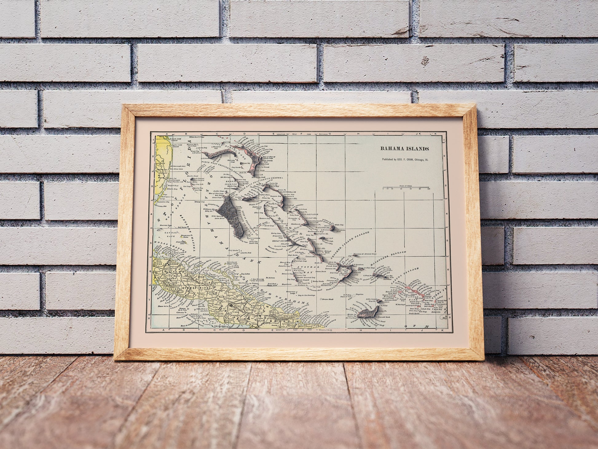 Vintage Bahamas shaded relief map in a wooden frame. Realistic terrain art print for home decor, displayed against a brick wall