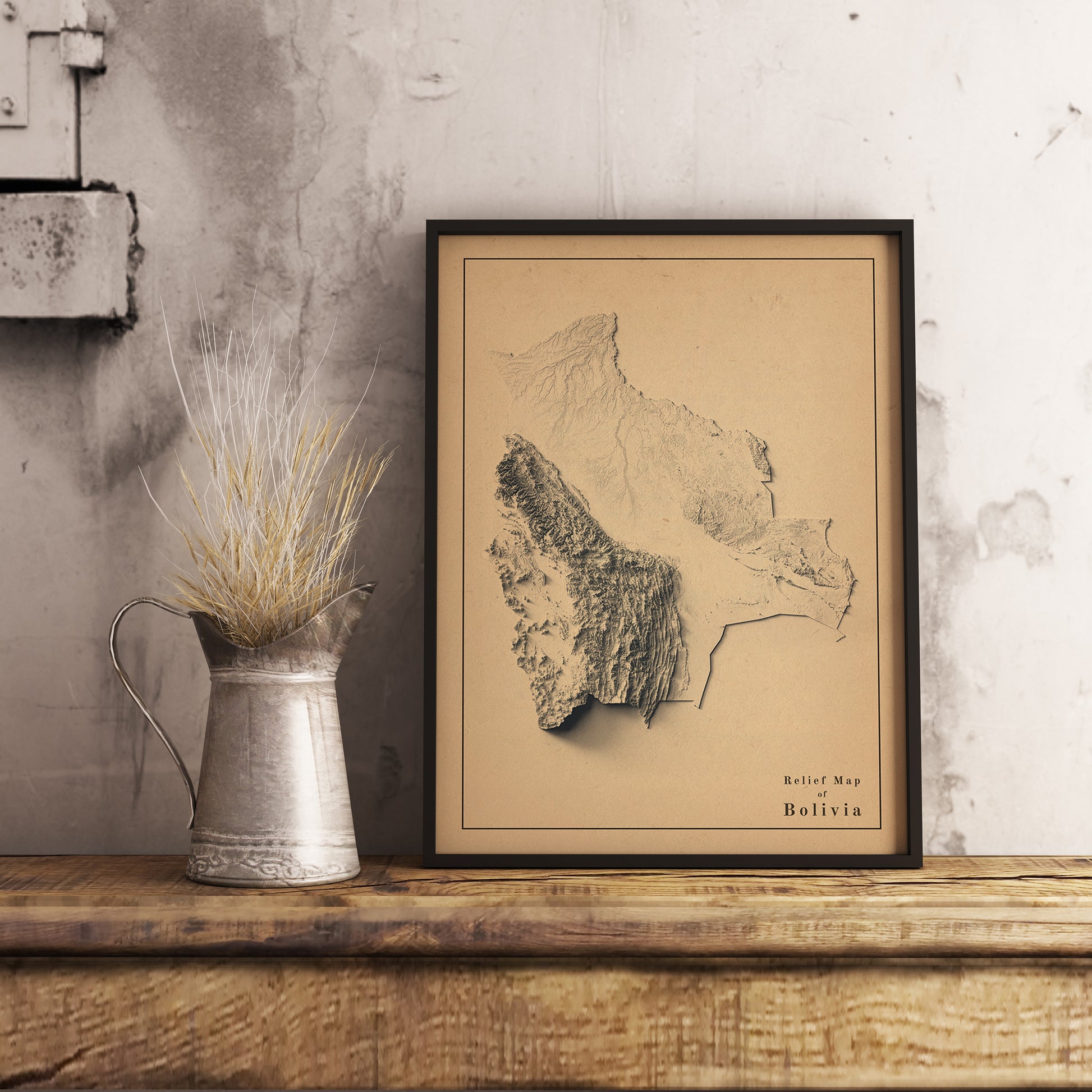 Vintage Bolivia shaded relief map in black frame. Realistic terrain art print for home decor, displayed on rustic wooden table