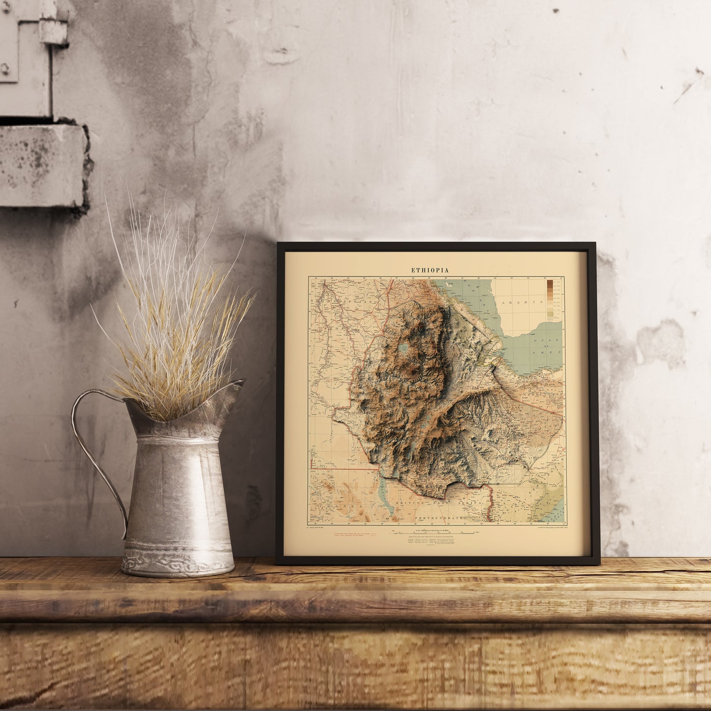 Vintage Ethiopia shaded relief map in black frame. Realistic terrain art print for home decor, displayed on rustic wooden table