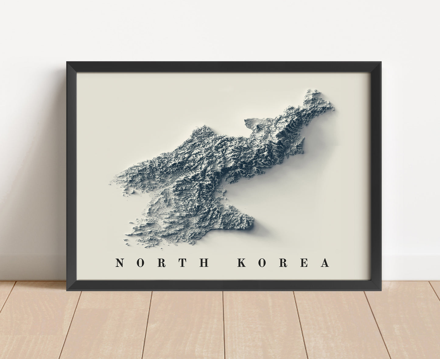 North Korea shaded relief map in black frame. Artistic print with realistic terrain effect for wall decor