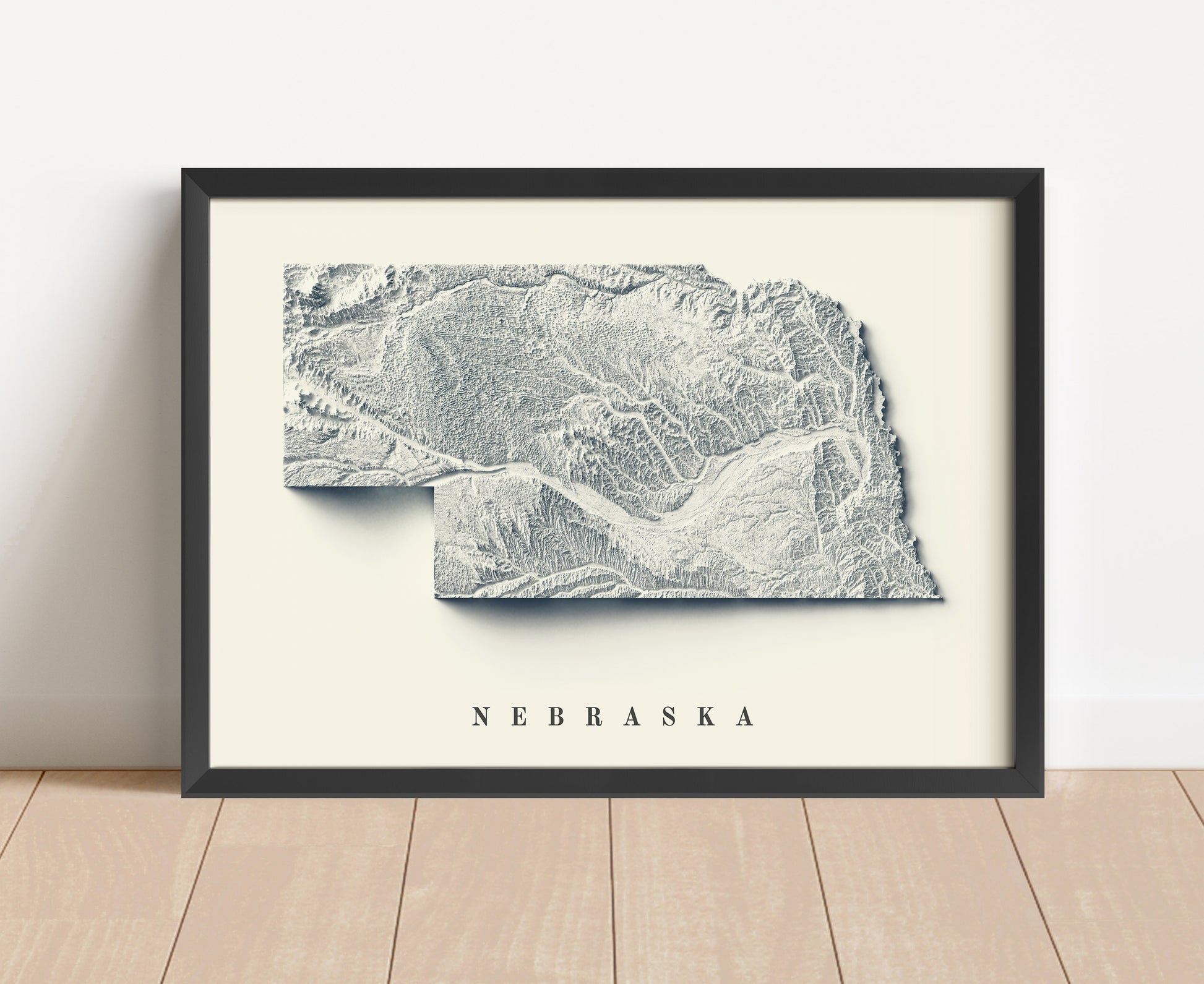 Nebraska shaded relief map in black frame. Artistic print with realistic terrain effect for wall decor