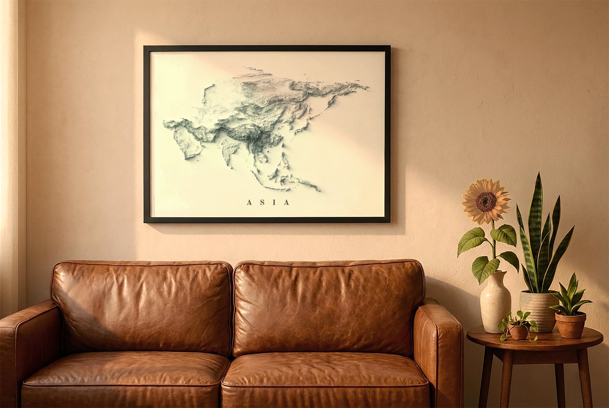 Asia relief map in a black frame above a brown leather sofa. Boho living room with warm sunlight, sunflower, and indoor plants on a wooden side table