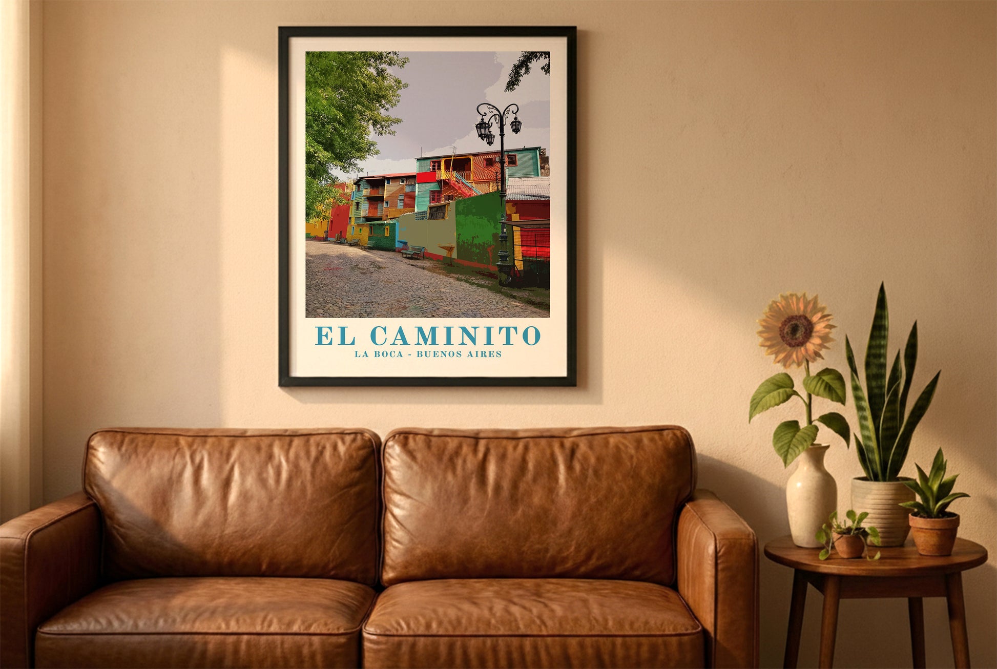 El Caminito, Buenos Aires, poster in a black frame above a brown leather sofa. Boho living room with warm sunlight, sunflower, and indoor plants on a wooden side table
