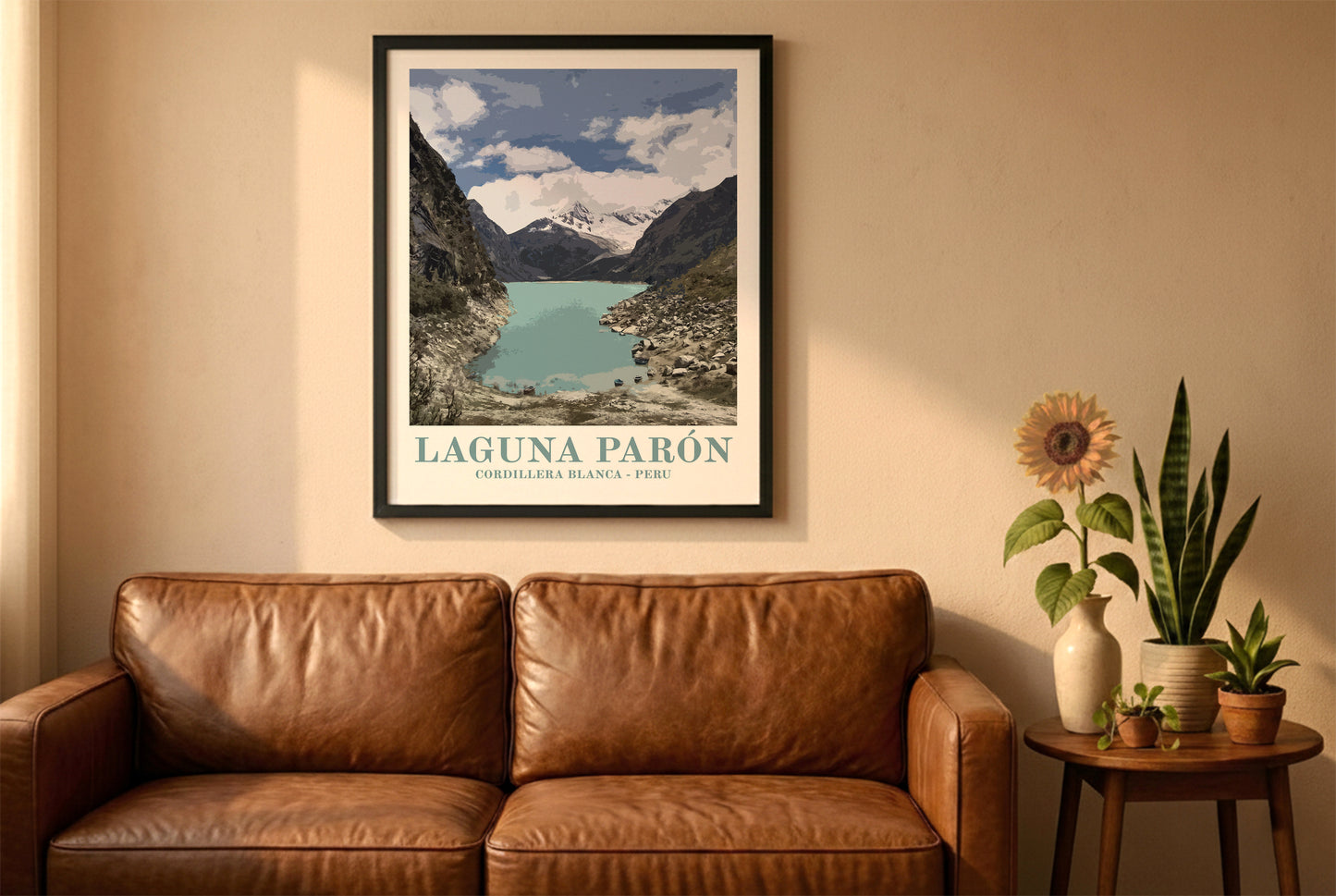 Laguna Paron poster in a black frame above a brown leather sofa. Boho living room with warm sunlight, sunflower, and indoor plants on a wooden side table