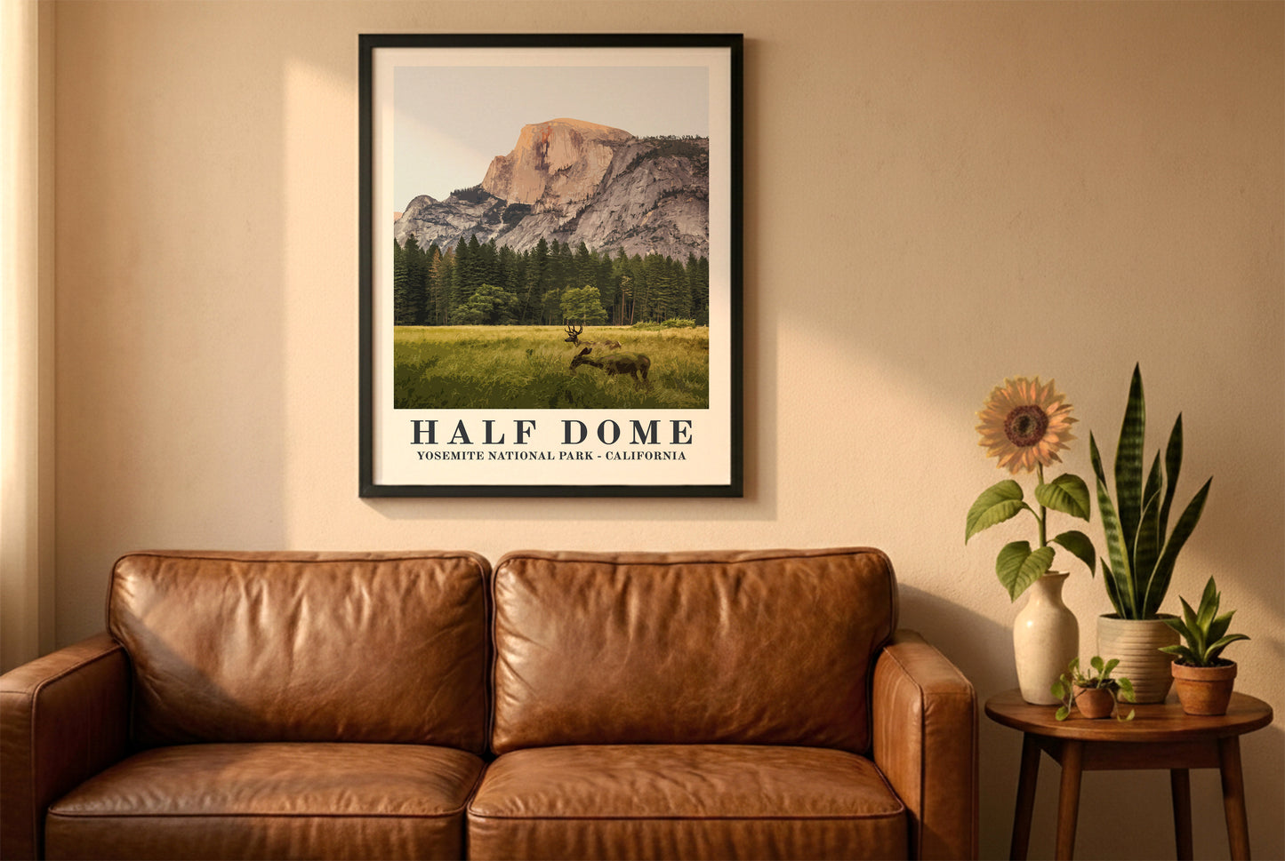 Yosemite National Park in a black frame above a brown leather sofa. Boho living room with warm sunlight, sunflower, and indoor plants on a wooden side table