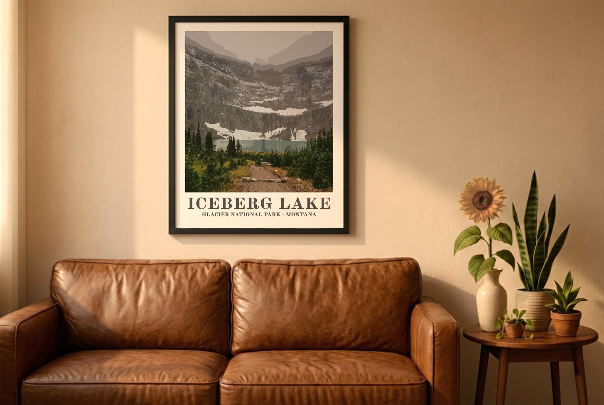 Glacier National Park poster in a black frame above a brown leather sofa. Boho living room with warm sunlight, sunflower, and indoor plants on a wooden side table