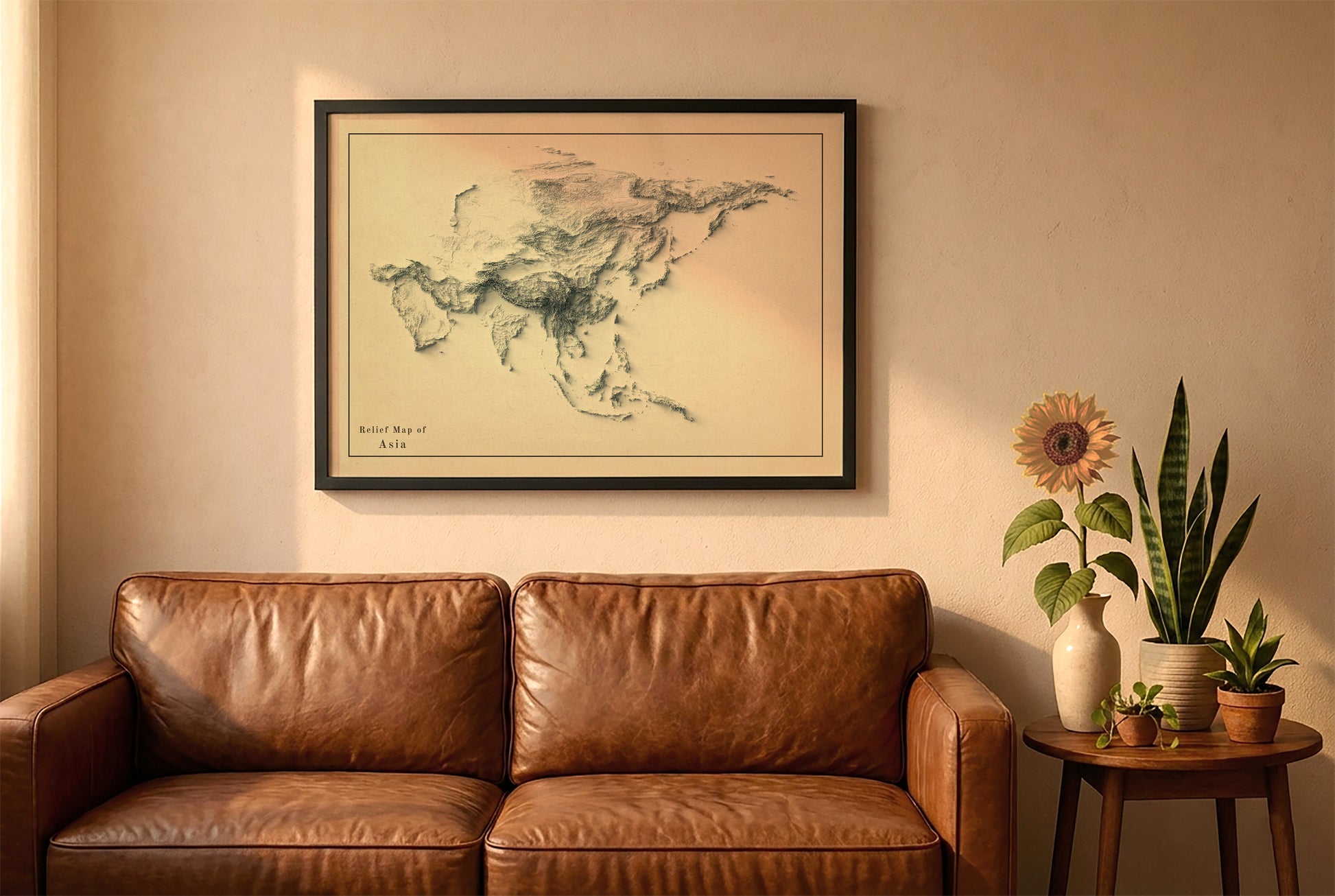Asia vintage relief map in a black frame above a brown leather sofa. Boho living room with warm sunlight, sunflower, and indoor plants on a wooden side table
