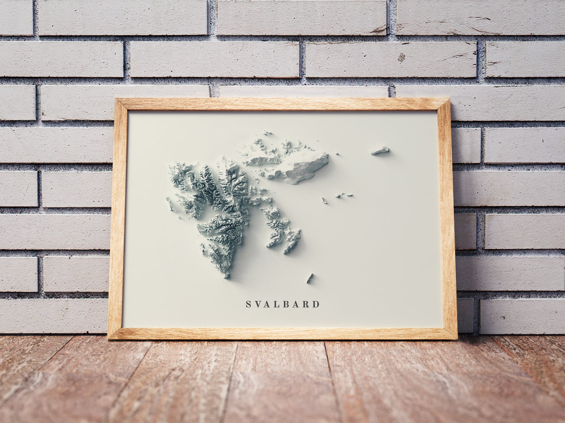 Svalbard, Norway, shaded relief map in a wooden frame. Realistic terrain art print for home decor, displayed against a brick wall