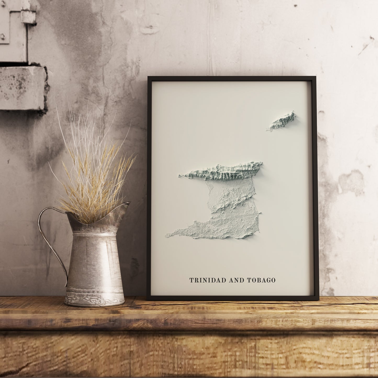 Trinidad and Tobago shaded relief map in black frame. Realistic terrain art print for home decor, displayed on rustic wooden table