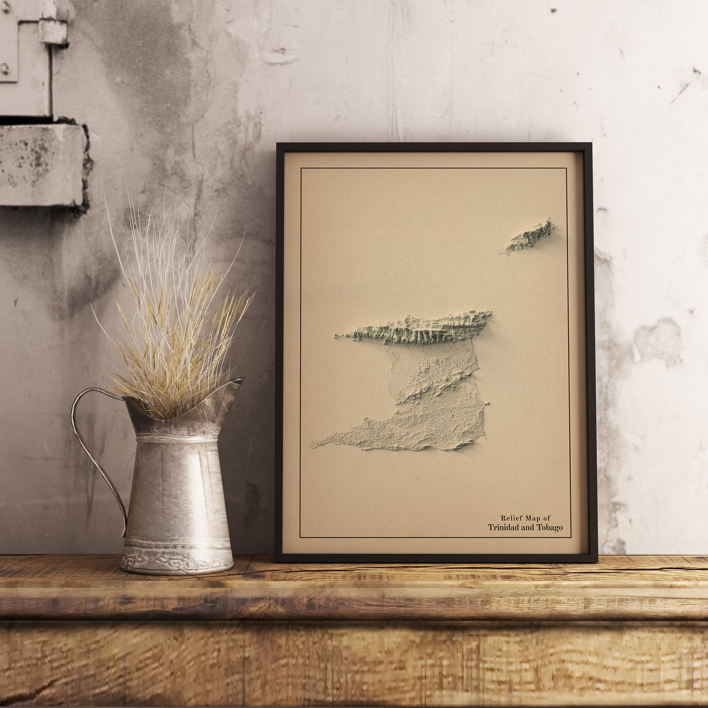 Vintage Trinidad and Tobago shaded relief map in black frame. Realistic terrain art print for home decor, displayed on rustic wooden table