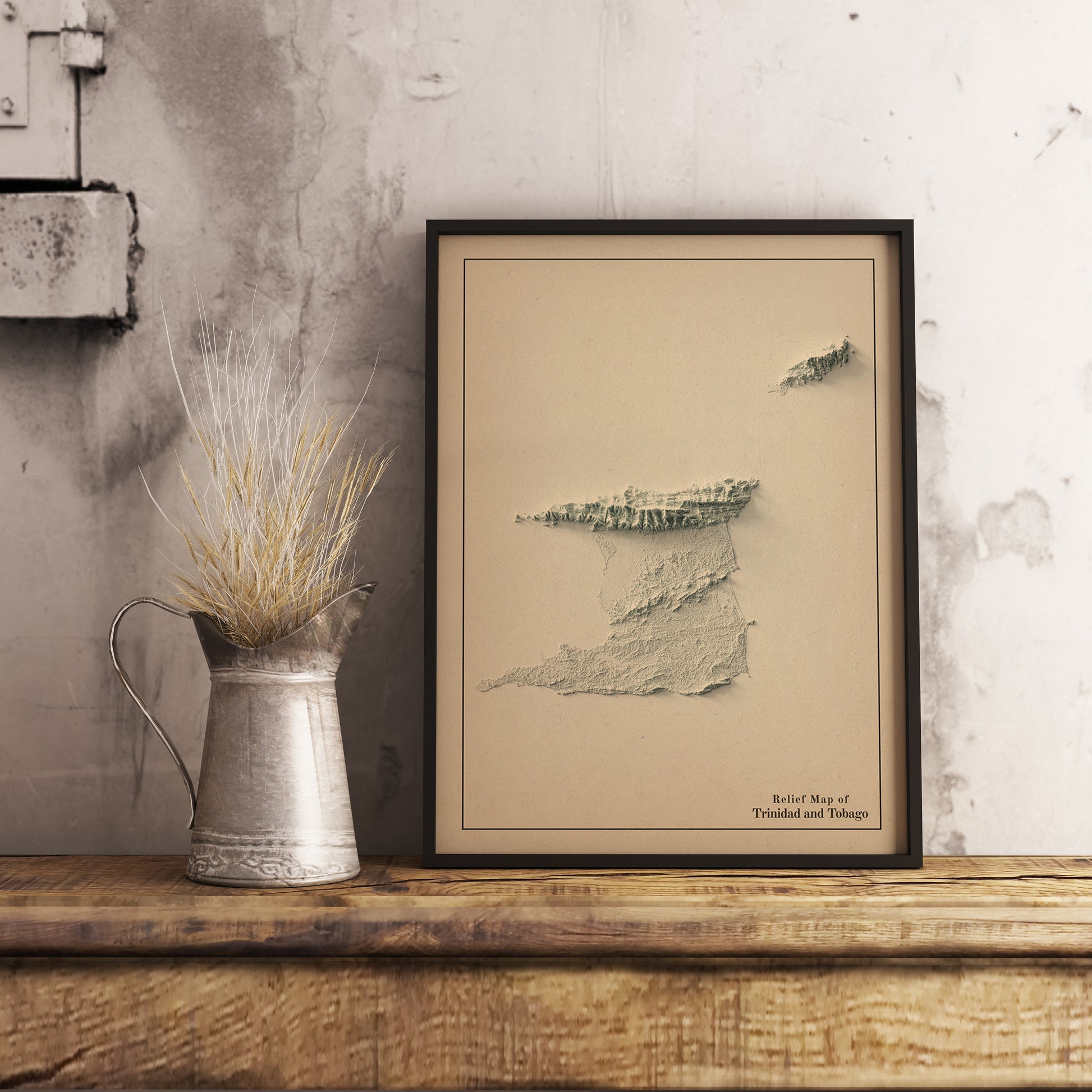 Vintage Trinidad and Tobago shaded relief map in black frame. Realistic terrain art print for home decor, displayed on rustic wooden table