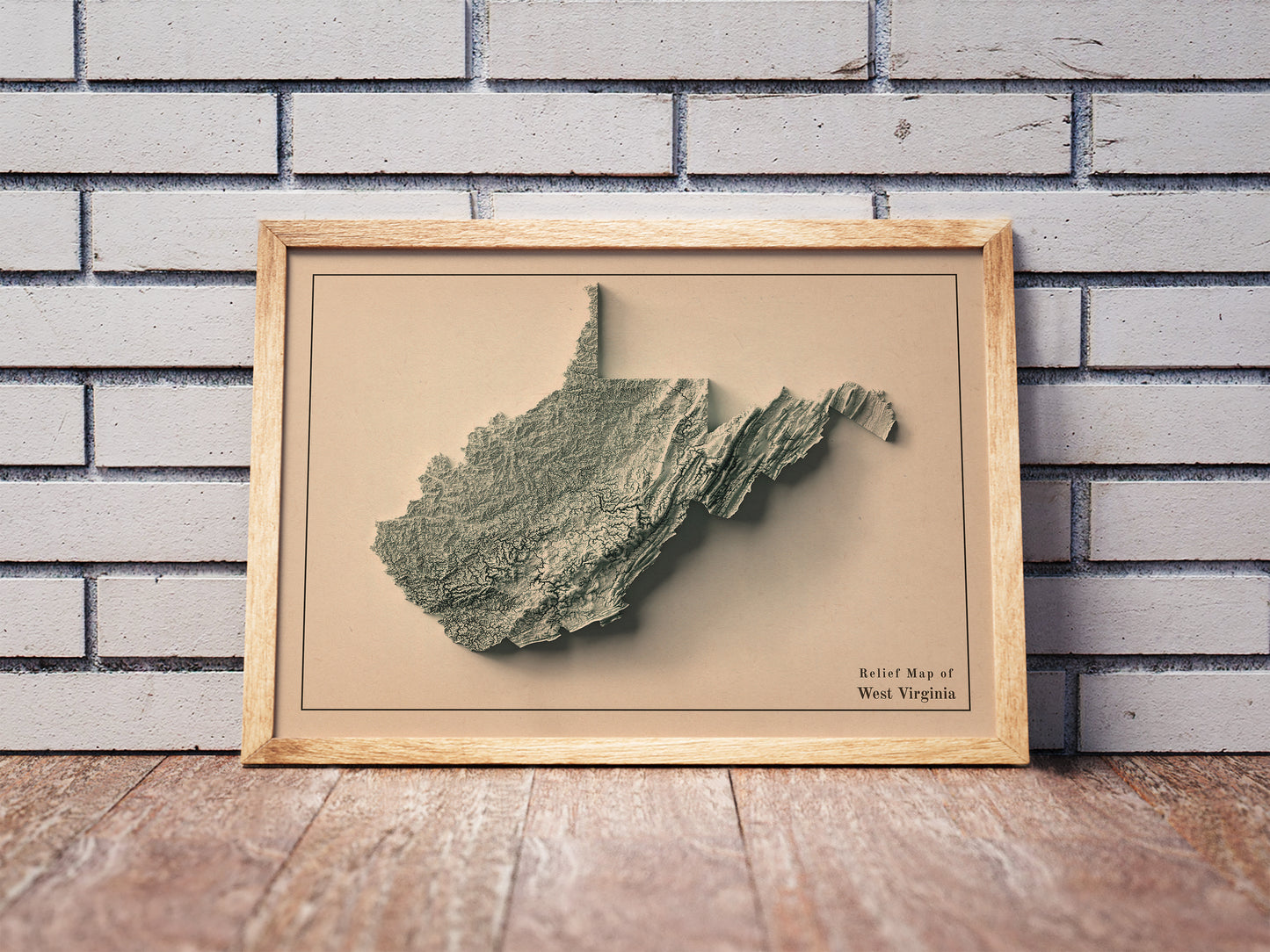 Vintage West Virginia shaded relief map in a wooden frame. Realistic terrain art print for home decor, displayed against a brick wall