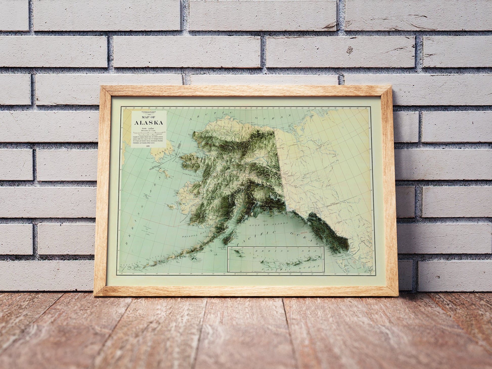 Vintage Africa shaded relief map in a wooden frame. Realistic terrain art print for home decor, displayed against a brick wall