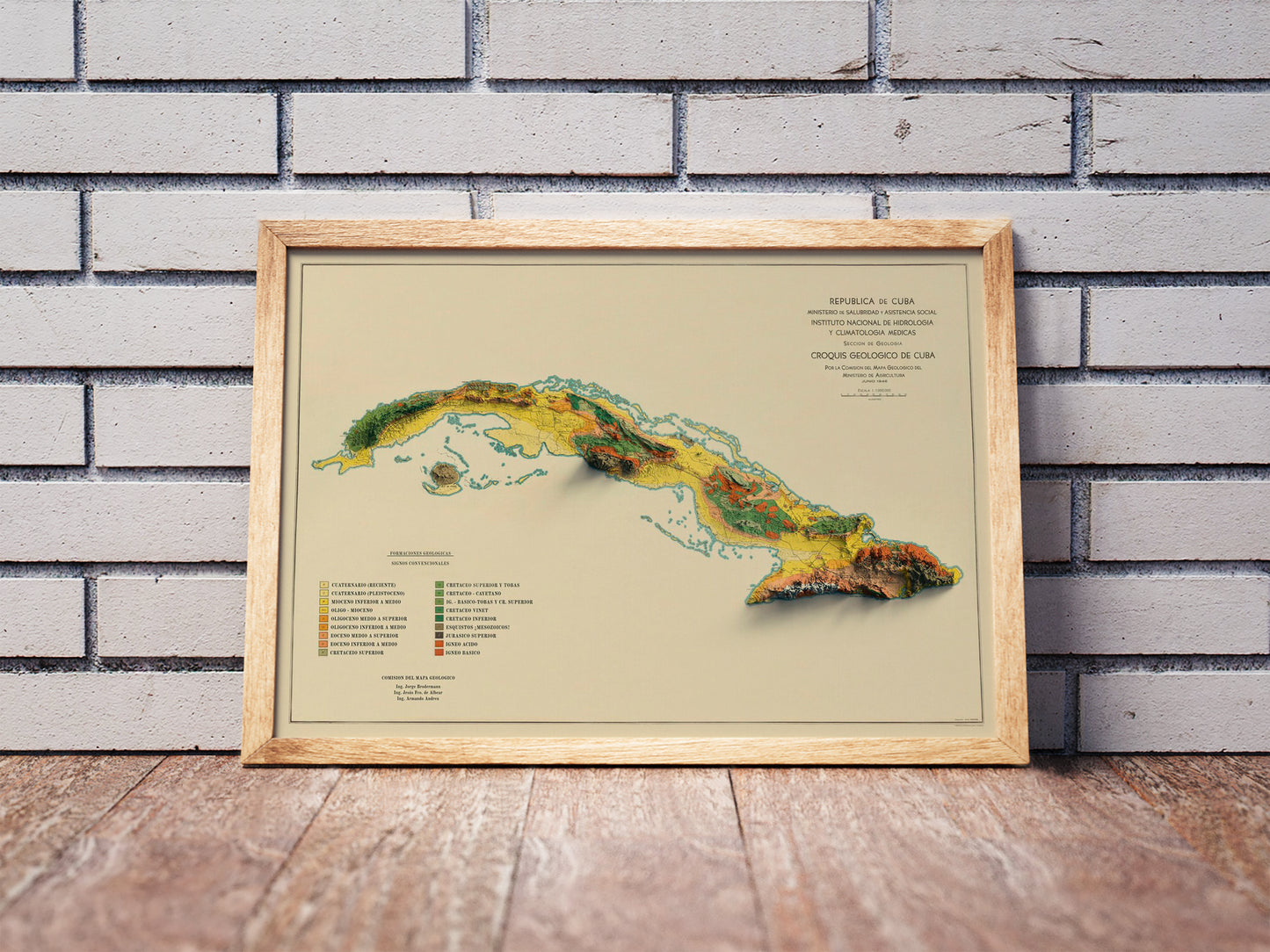 Vintage Cuba shaded relief map in a wooden frame. Realistic terrain art print for home decor, displayed against a brick wall