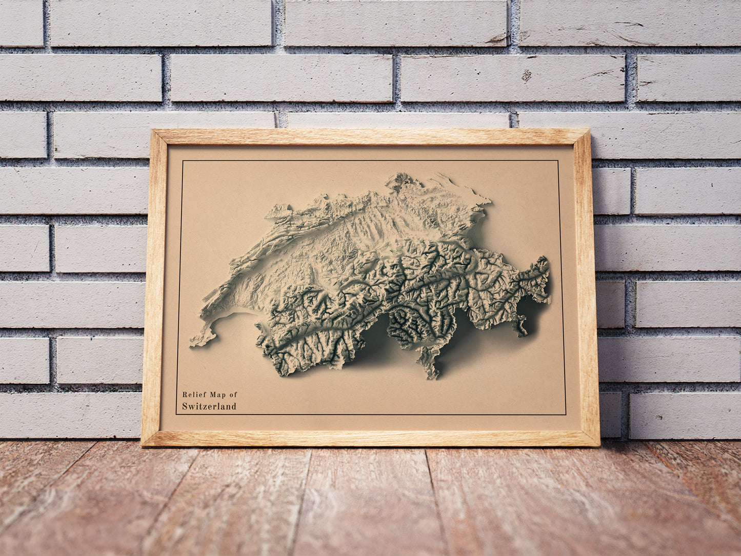 Vintage Switzerland shaded relief map in a wooden frame. Realistic terrain art print for home decor, displayed against a brick wall
