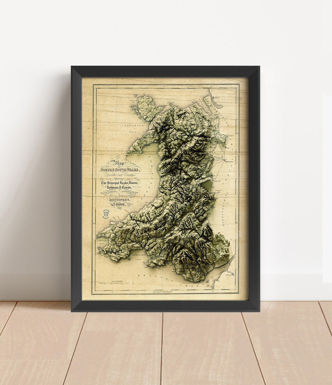 Vintage Wales shaded relief map in black frame. Artistic print with realistic terrain effect for wall decor