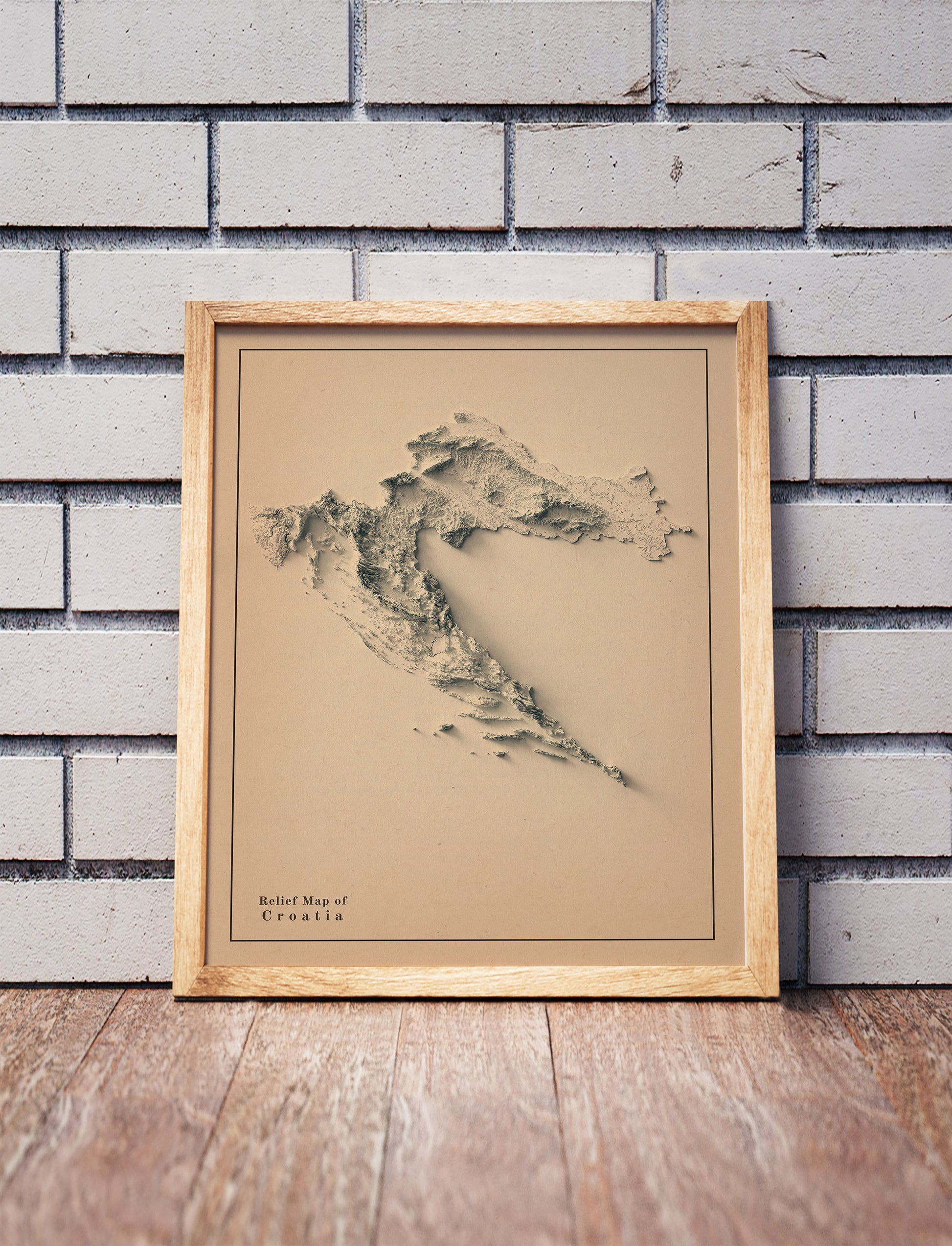 Vintage Croatia shaded relief map in a wooden frame. Realistic terrain art print for home decor, displayed against a brick wall