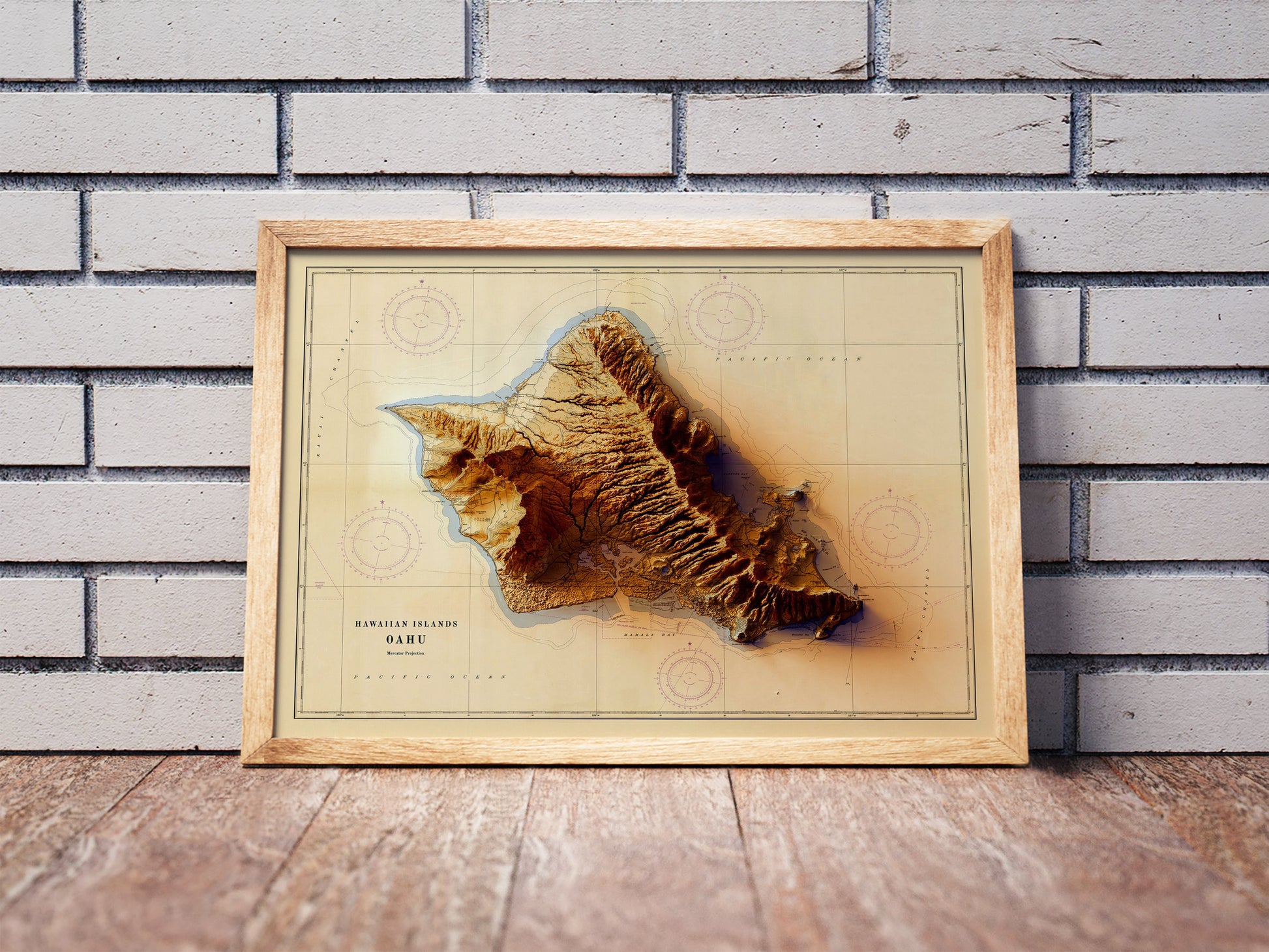 Vintage Oahu, Hawaii, shaded relief map in a wooden frame. Realistic terrain art print for home decor, displayed against a brick wall