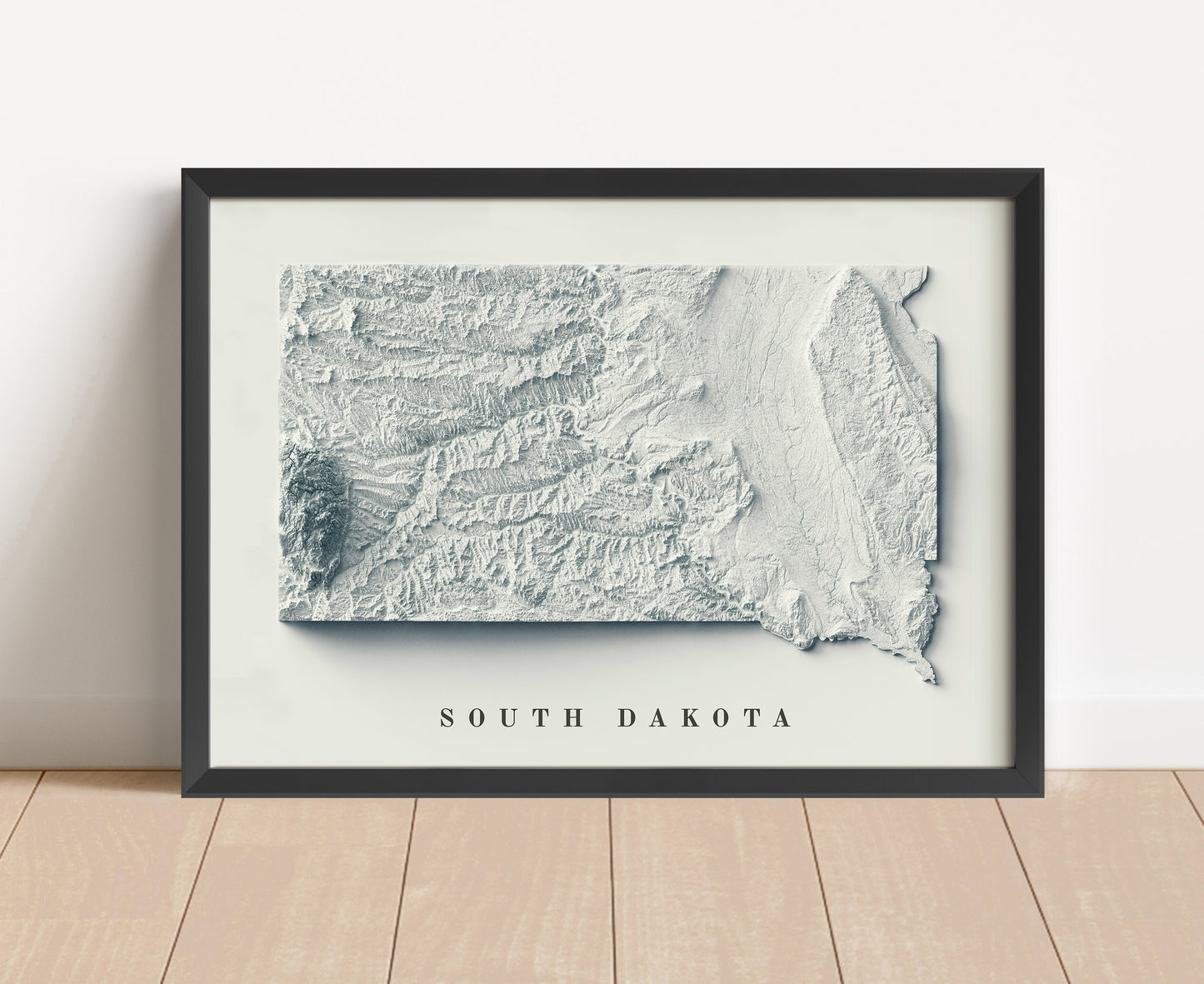 South Dakota shaded relief map in black frame. Artistic print with realistic terrain effect for wall decor