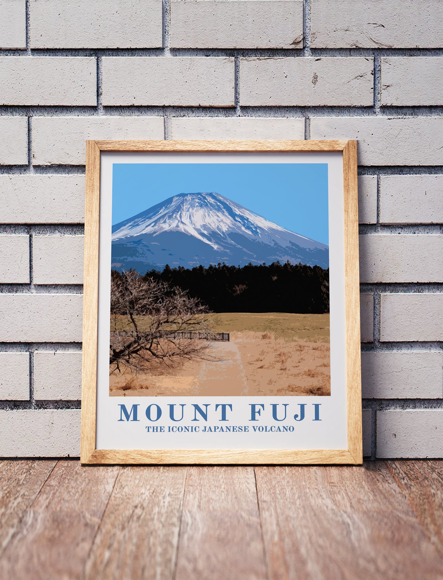 Mount Fuji, Japan, poster in a wooden frame. Realistic terrain art print for home decor, displayed against a brick wall