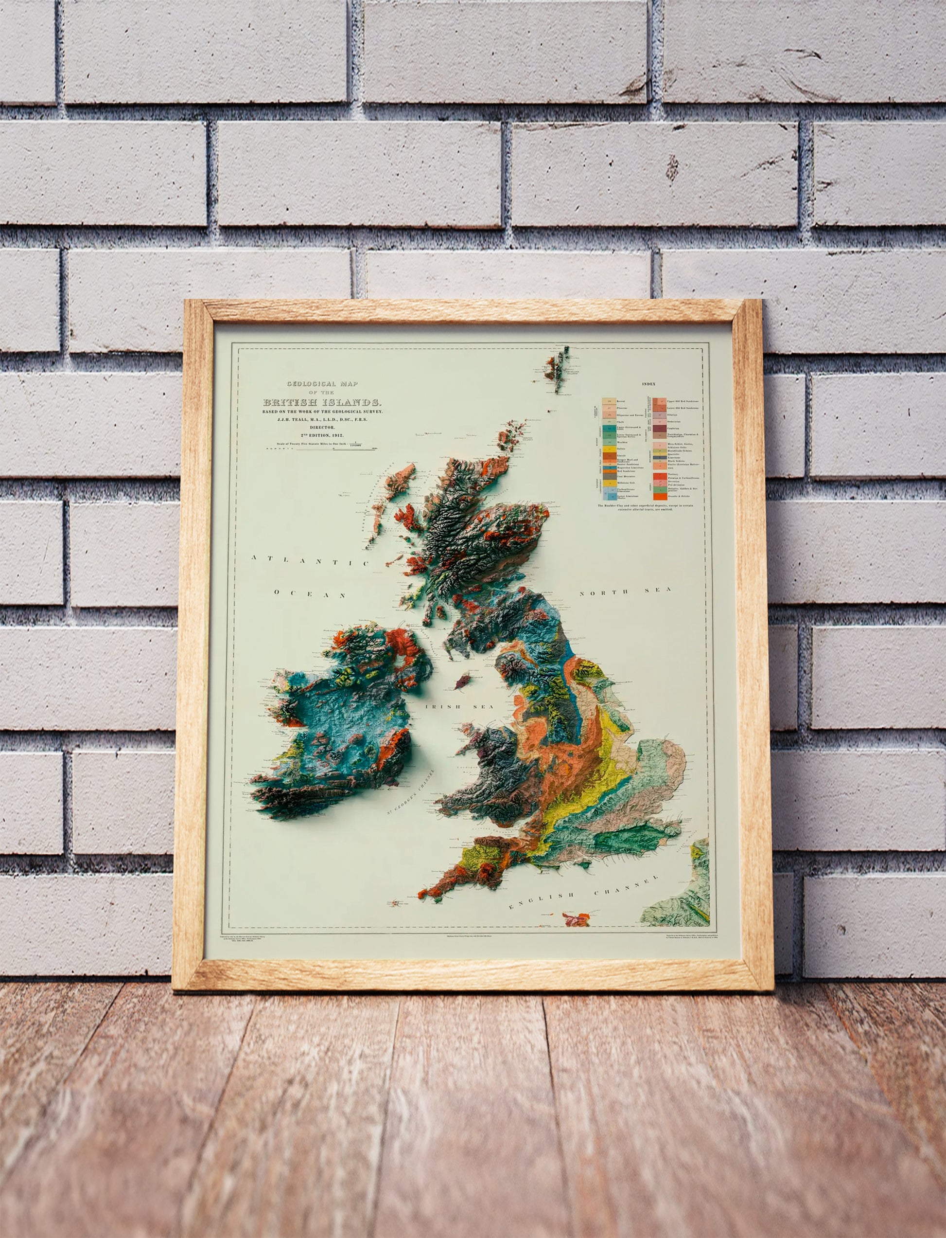 Vintage England, Wales, Scotland, Ireland shaded relief map in a wooden frame. Realistic terrain art print for home decor, displayed against a brick wall
