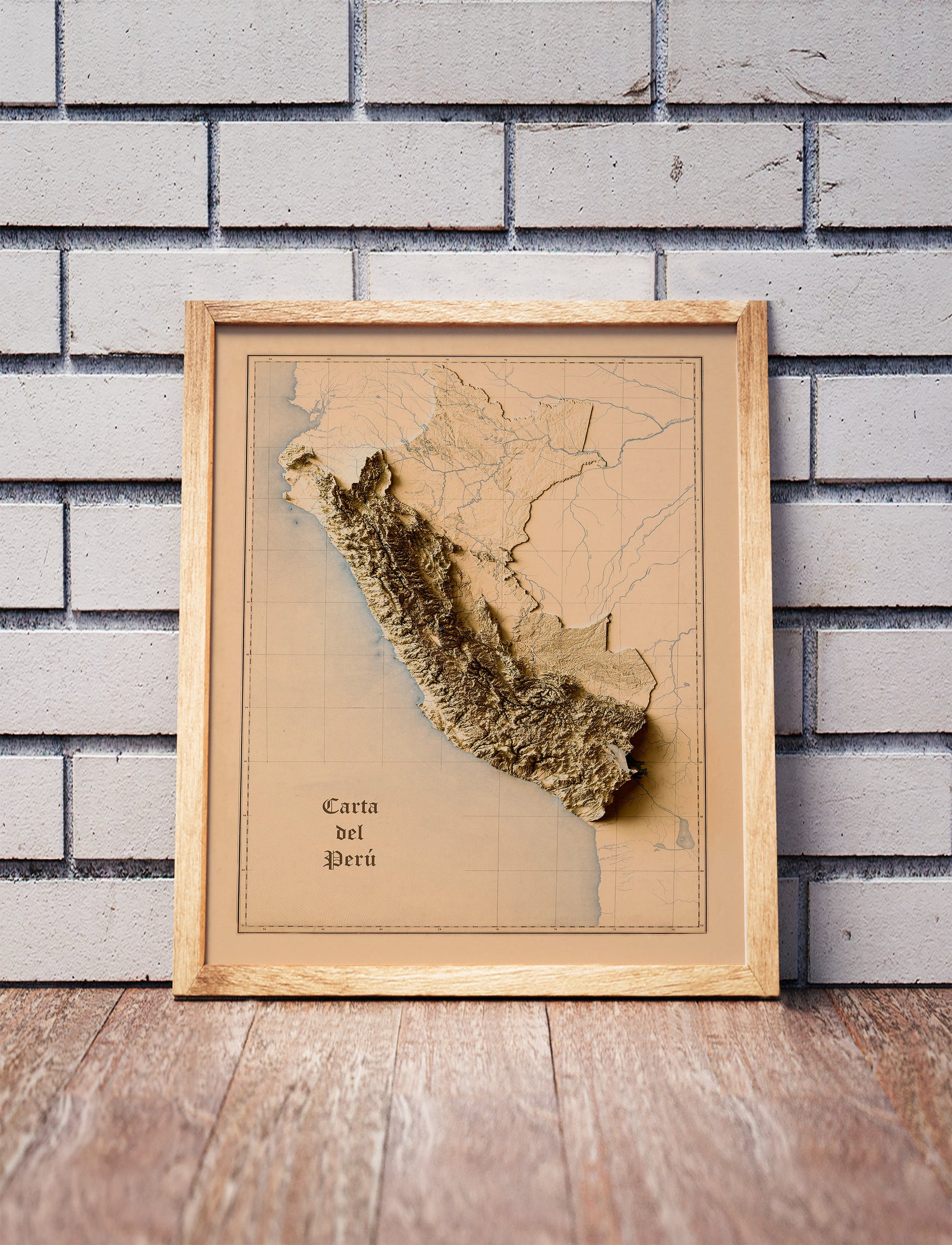 Vintage Peru shaded relief map in a wooden frame. Realistic terrain art print for home decor, displayed against a brick wall